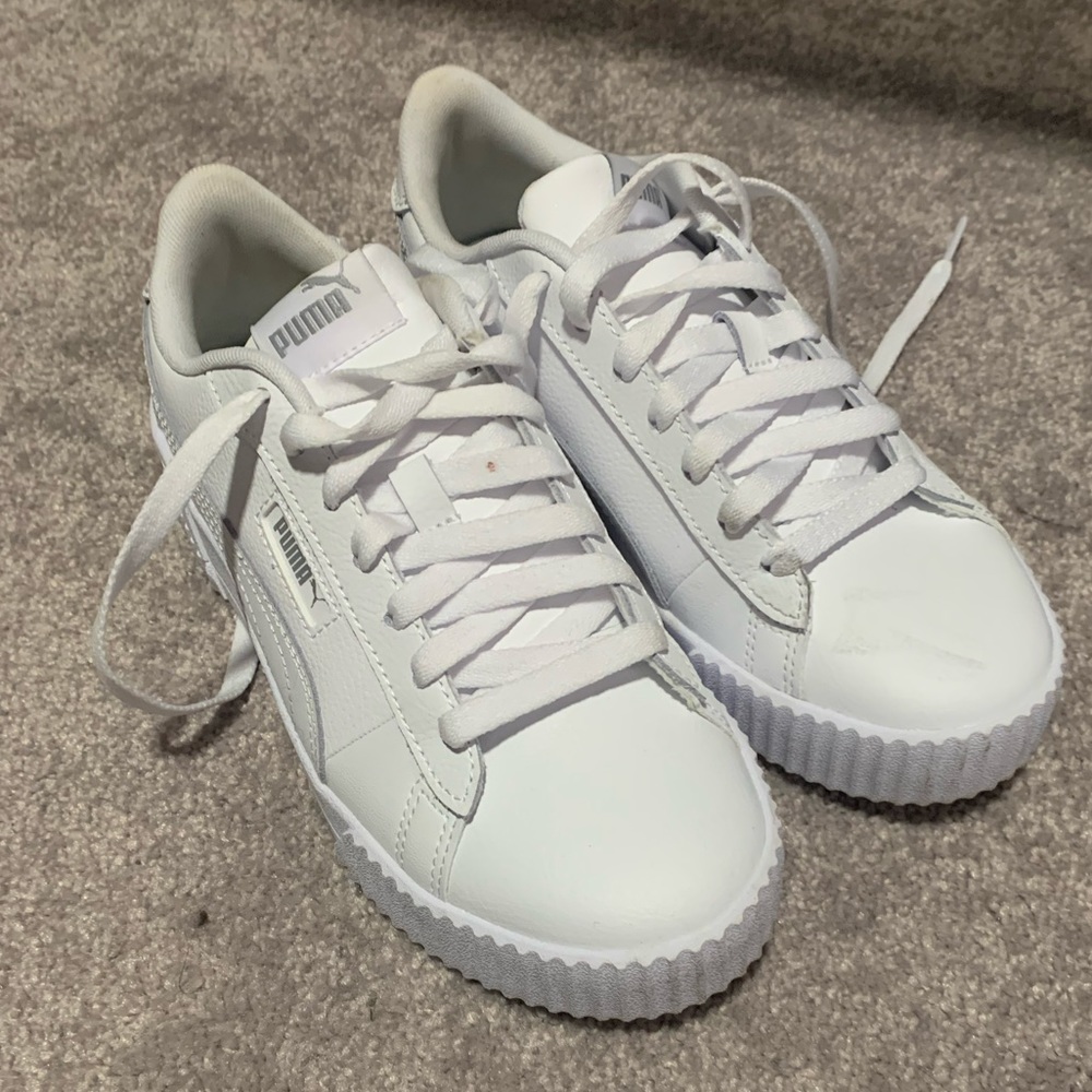 White leather Puma sneakers.